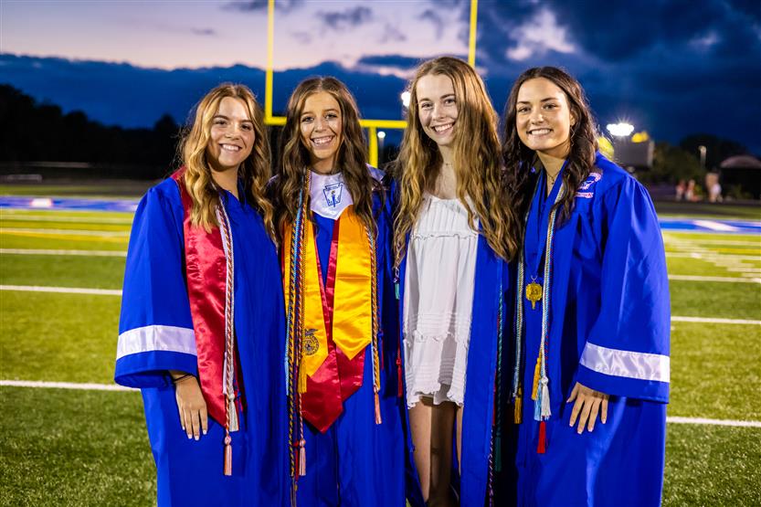 Students in blue robes graduate
